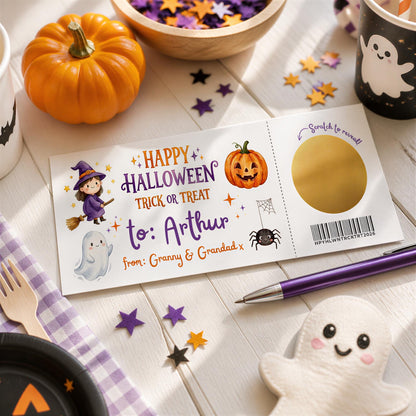 a Halloween-themed card with a pumpkin, ghost, spider, and other spooky decorations, along with a pen and a small ghost figure.