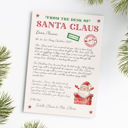 The image is a Christmas-themed letter from Santa Claus to Marie, addressed as "From the Desk of Santa Claus". The letter is handwritten and includes a Santa Claus illustration and a Christmas tree in the background.