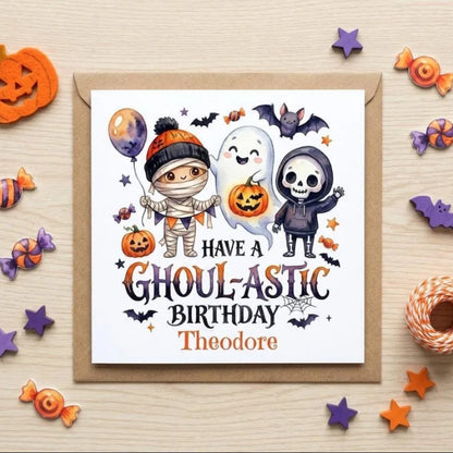 Halloween-themed birthday card with illustrations of a mummy, ghost, skeleton, pumpkin, candy, and stars.