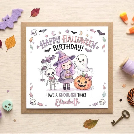 A birthday card with a Halloween theme, featuring a girl with purple hair, a skeleton, a ghost, a pumpkin, and bats. The card has a message that reads "Happy Halloween Birthday! Have a Ghoul-ish time! Elizabeth". The card is surrounded by Halloween-themed items such as candy, a key, and a skeleton.