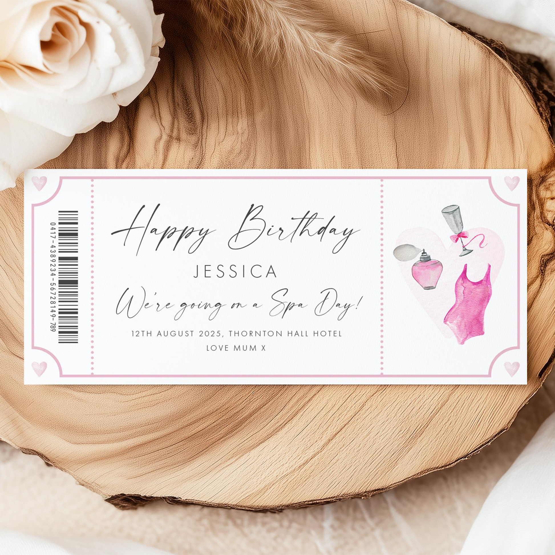 A birthday gift ticket for Jessica, with a pink rose and a spa day illustration, placed on a wooden surface.