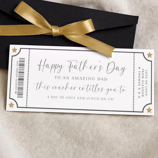 A gift card for Father's Day, with a gold ribbon and a black envelope.