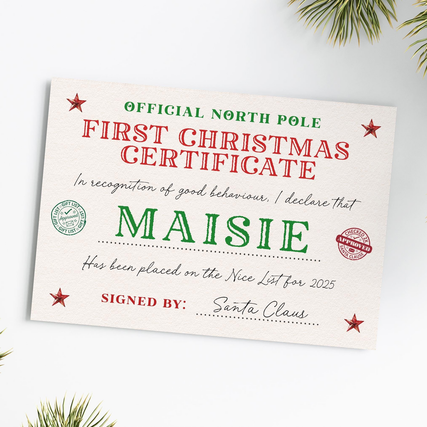 The image is a Christmas-themed certificate or card with the text "First Christmas Certificate" and "Maisy" written on it. The certificate is signed by Santa Claus.