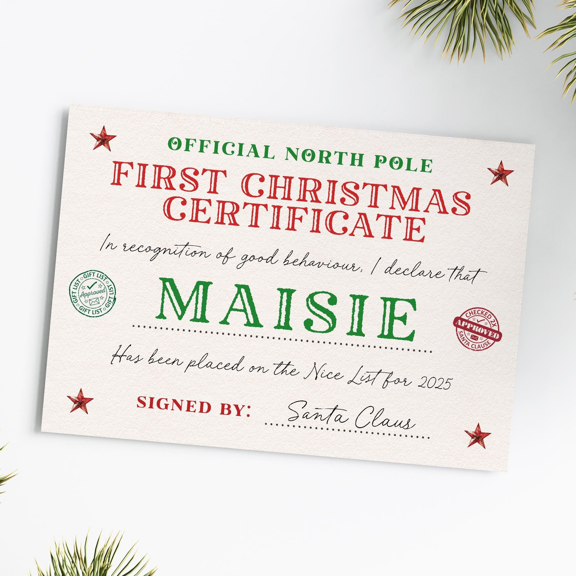 The image is a Christmas-themed certificate or card with the text "First Christmas Certificate" and "Maisy" written on it. The certificate is signed by Santa Claus.