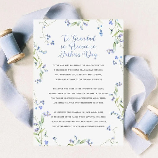 a floral-designed card with a heartfelt message for a father's day, accompanied by a ribbon and spool of thread.