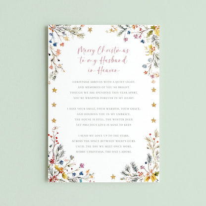 May include: A rectangular white greeting card featuring a floral border with pine needles, berries, and gold stars. The text reads: Merry Christmas to my Husband in Heaven, followed by a poem about missing a loved one during the holiday season.
