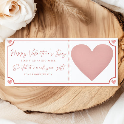 a Valentine's Day card with a pink heart and a message about a gift.