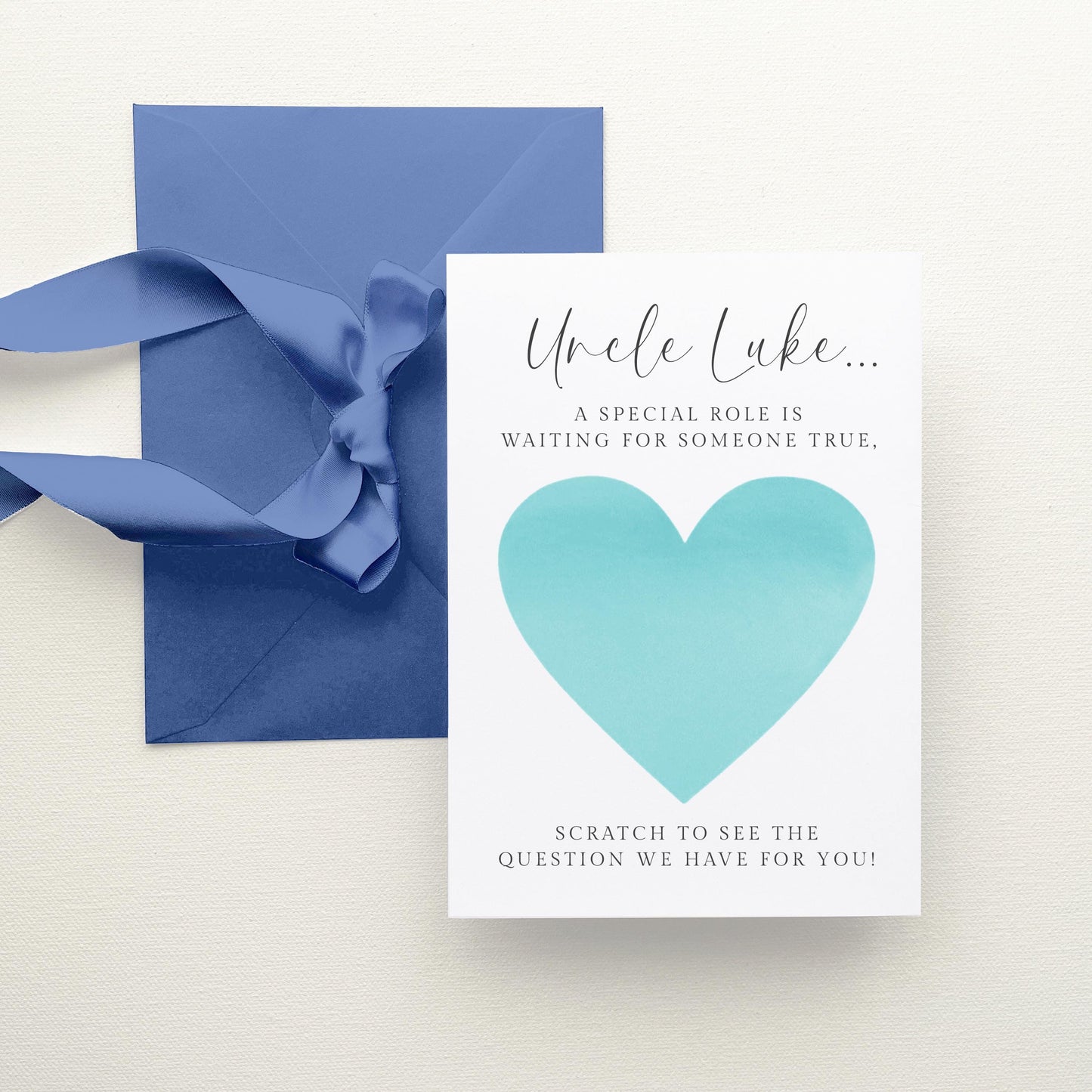 a card with a blue envelope and a heart-shaped sticker on it.