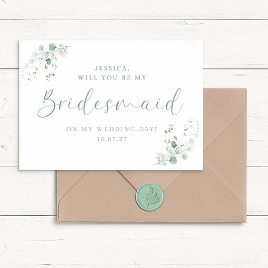A wedding invitation card with a bridesmaid request, placed on a wooden surface.