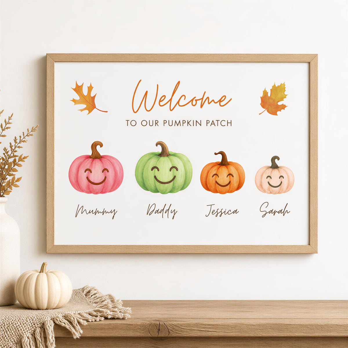 a framed sign with a welcoming message for a pumpkin patch, accompanied by four smiling pumpkins representing different family members.
