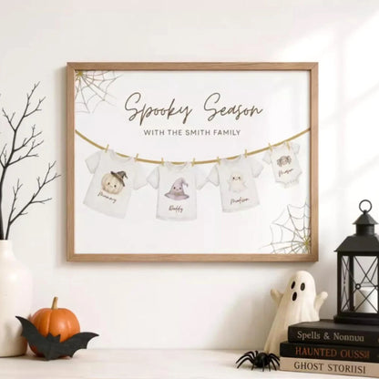 a framed artwork hanging on a wall, depicting a spooky scene with t-shirts and Halloween-themed decorations.
