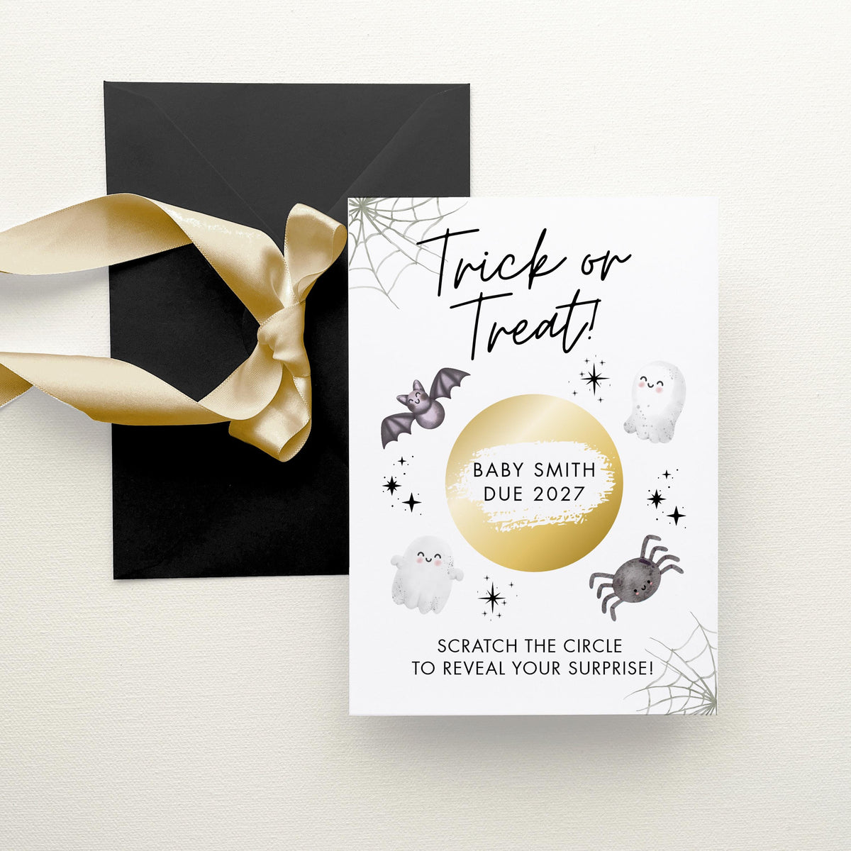 a Halloween-themed card with a black envelope and a gold ribbon. The card has a black background with white text and illustrations, including a spider web, bats, a ghost, and a spider.