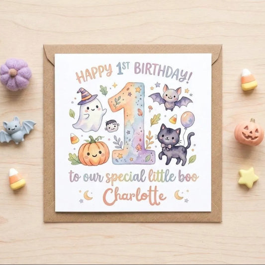 A birthday card for a 1-year-old girl named Charlotte, celebrating her first birthday. The card features illustrations of a ghost, a cat, a pumpkin, and bats, along with the text "Happy 1st Birthday!" and "to our special little boo Charlotte".
