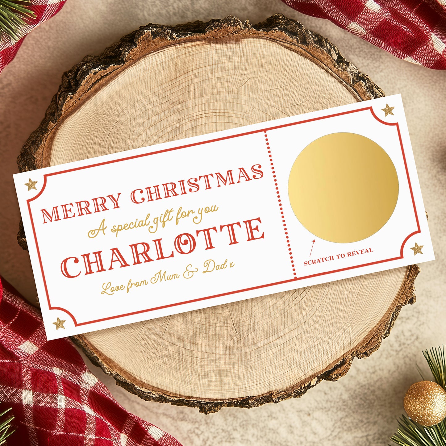 A white Christmas gift card with a gold center, placed on a wooden surface with a red and white checkered cloth and Christmas decorations in the background.