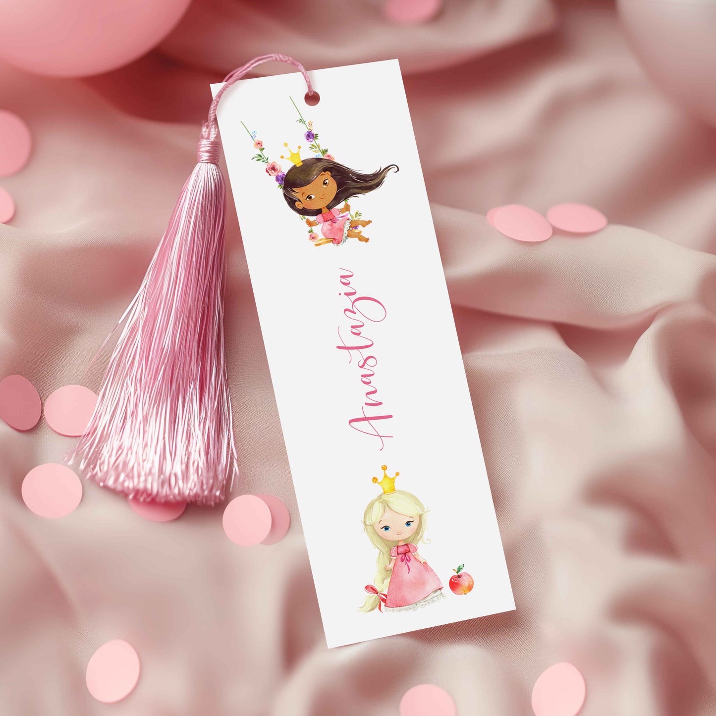A white bookmark with a pink tassel and illustrations of two princesses, one blonde and one brunette, on a pink background.