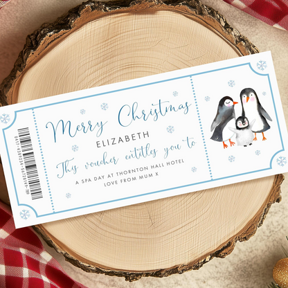 A Christmas-themed gift voucher for a spa day at Thornton Hall Hotel, with illustrations of penguins and snowflakes.