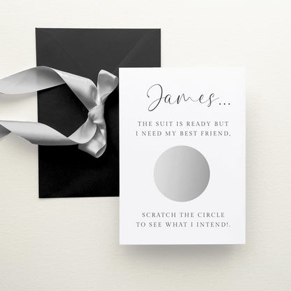a black envelope with a silver ribbon, and a white card with text and a silver circle.