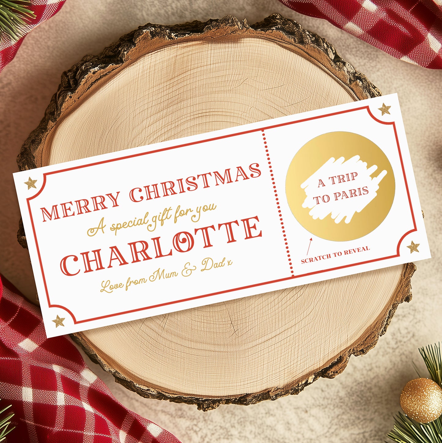 A Christmas gift ticket for Charlotte, with a personalized message and a scratch-off element, placed on a wooden surface with a red and white checkered cloth and Christmas decorations.